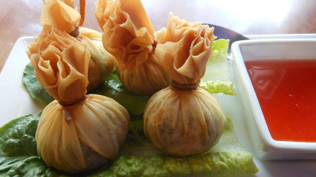 Malakor Thai Isaan’s Money Bags, eggroll skins stuffed with a mash of sweet potato and peas tied into a pouch