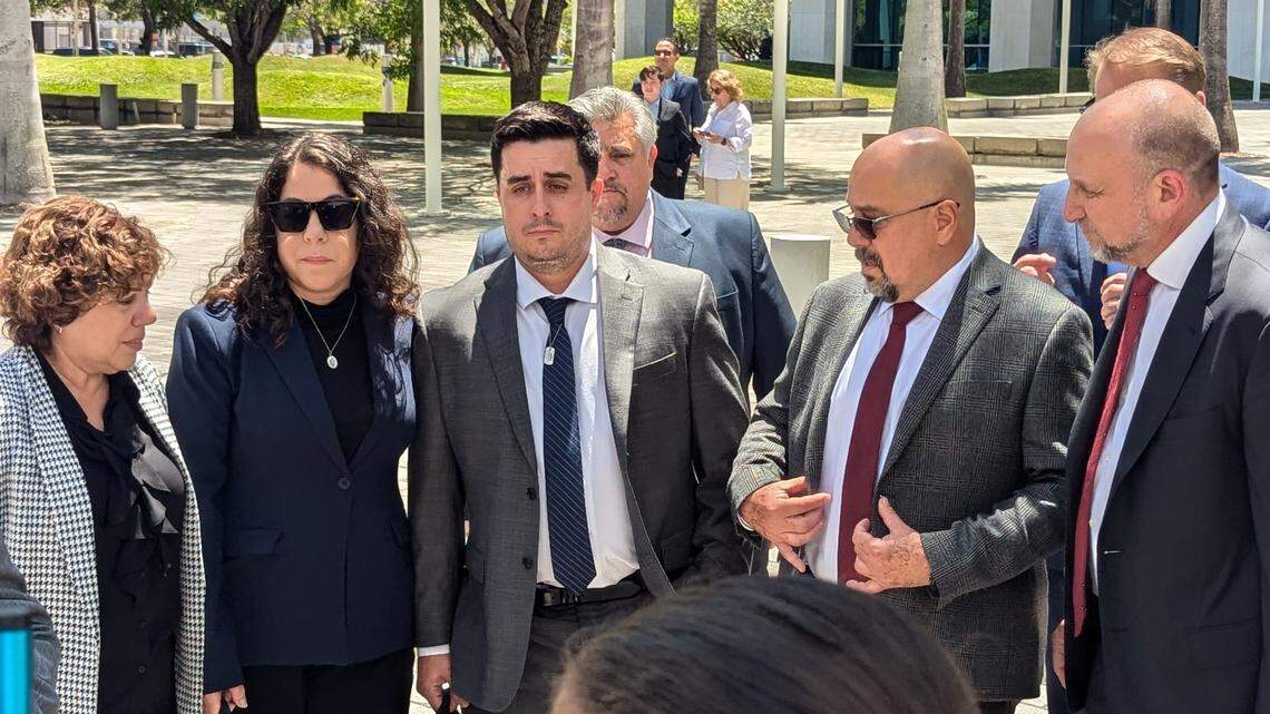 Dillon Angulo, center with tie, stands next to Neima Benavides, the sister of Dillon’s girlfriend Naibel Benavides Leon, who was killed in the Florida Keys crash in 2019 near the Ocean Reef Club. Angulo’s body was nearly shattered from the crash.