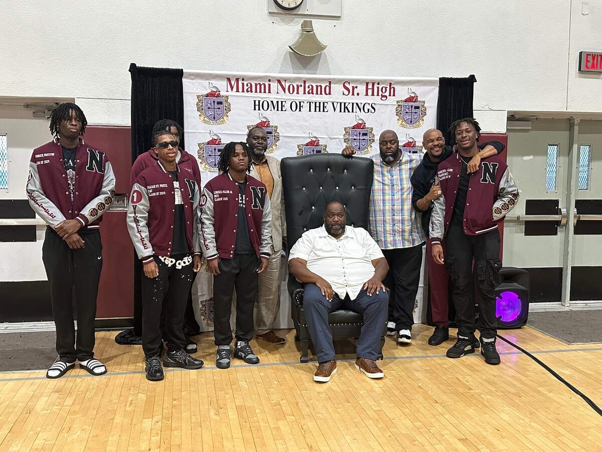 Miami Norland boys’ basketball coach Lawton Williams III (middle) is flanked by members of the Vikings’ 2023-24 state championship team, which was in attendance at a ceremony this past week where the school announced it would rename its gym in his honor.