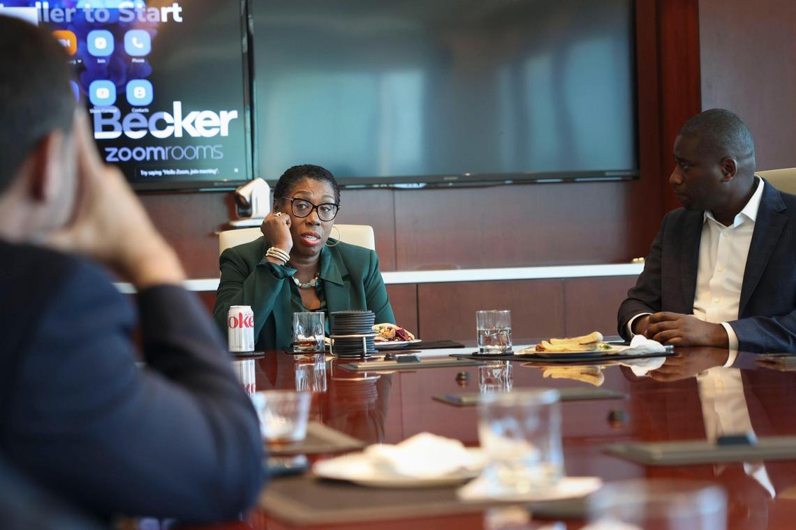 Yolanda Cash Jackson, the first Black chair of the Miami-Dade Beacon Council, center, speaks to a group in a conference room at the Becker law firm in downtown Fort Lauderdale.
