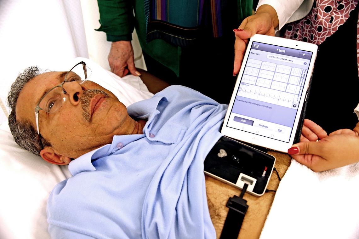 Jose Francisco is given a reading by the heart telemetry machine, Feb. 6, 2019. Elaine Bloom, CEO of Plaza Health Systems, decided to add telemetry machines so that EKGs could be given to patients in bed. The machine wound up detecting Bloom’s heart attack, in real time.