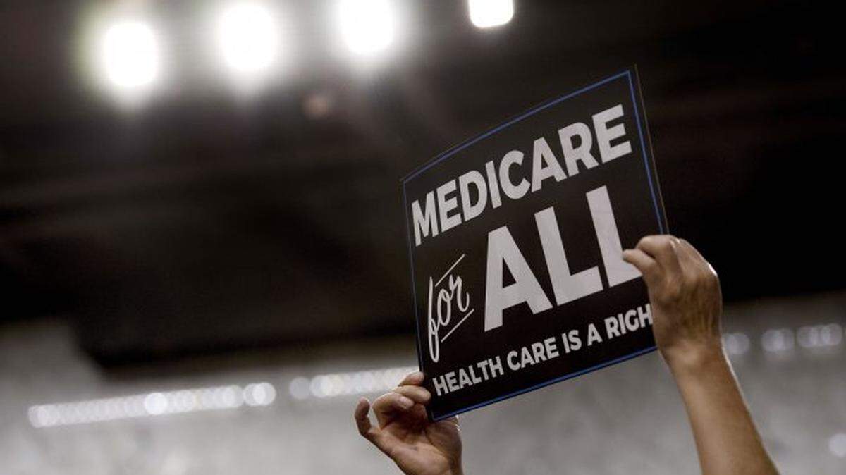 An audience member holds up a placard as Sen. Bernie Sanders discusses Medicare for All legislation on Capitol Hill.