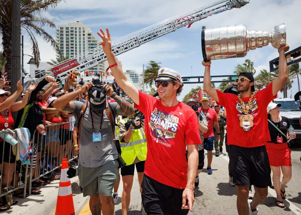 Florida Panthers center Carter Verhaeghe (23) waves to fans while Florida Panthers defenseman Seth Jones (3) hols the Stanley Cup during the Florida Panthers Stanley Cup Championship victory parade on Sunday, June 22, 2025 down Las Olas in Fort Lauderdale, Fla.