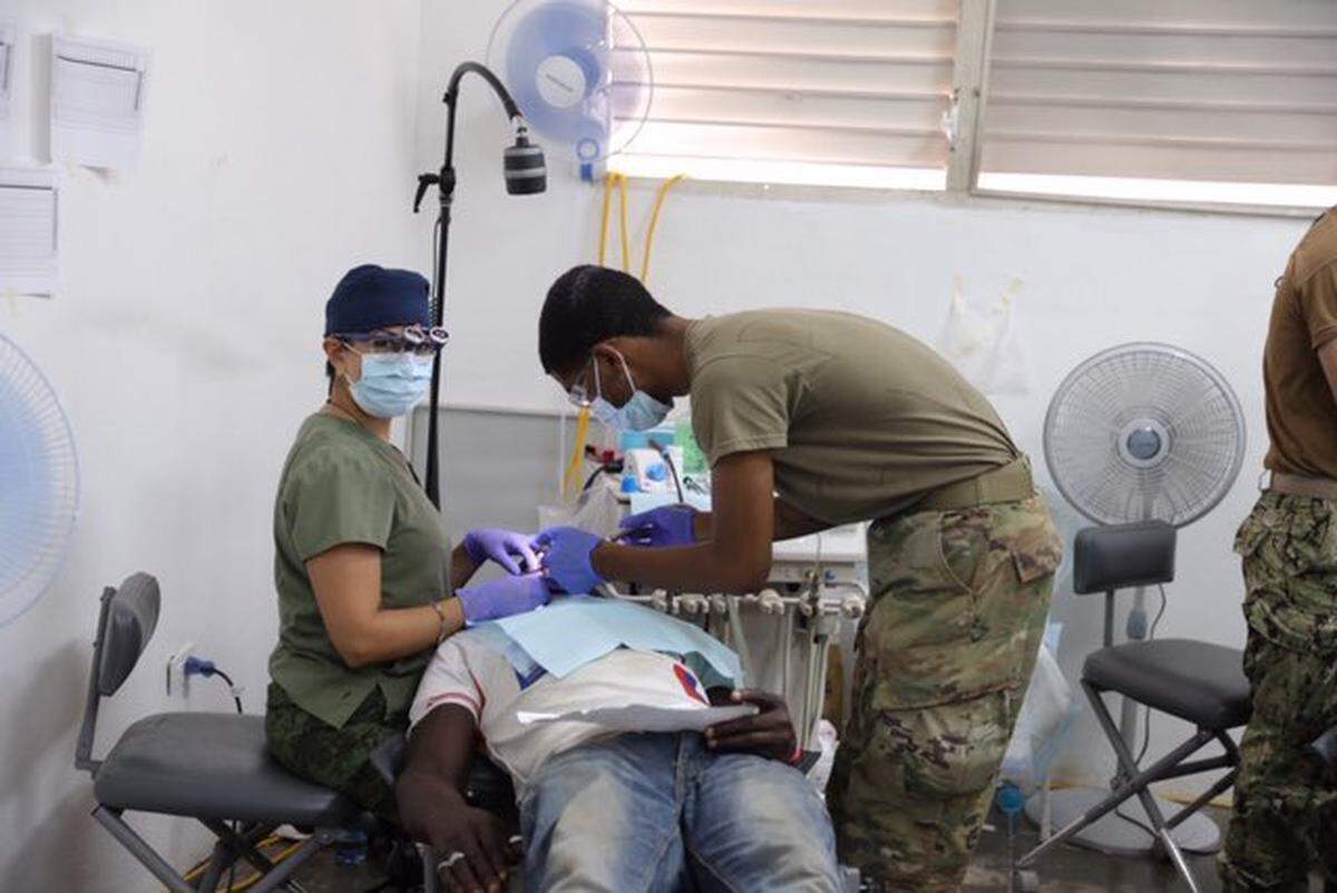 A dentist from Mexico treats a Haitian patient aboard the USNS Comfort naval hospital ship Thursday in Haiti. The ship arrived on Monday and will remain in the country until Wednesday.