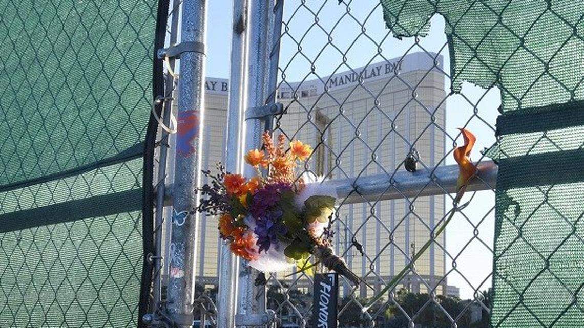 Flowers and a sign that says “Honor 58” hang on a fence across from Mandalay Bay Resort and Casino in Las Vegas, a tribute to those killed there in 2017.