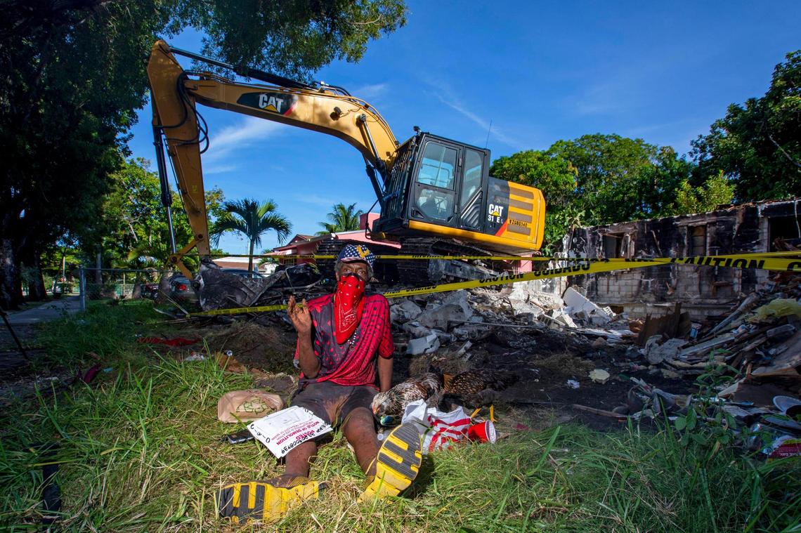 Michael Hamilton sits near the heavy machinery used to level his home in Liberty City. Hamilton, 70, grew up in the home, which his parents owned.