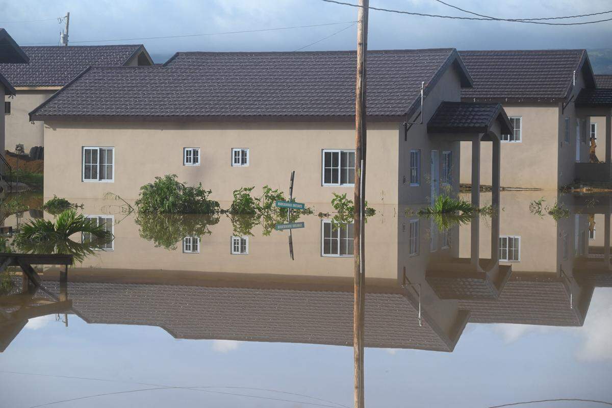 Flooded homes are seen after the passage of Hurricane Melissa in Howard Acres neighborhood in St. Elizabeth, Jamaica on October 29, 2025. Hurricane Melissa ripped up trees and knocked out power after making landfall in Jamaica on October 28, 2025 as one of the most powerful hurricanes on record, inundating the island nation with rains that threaten flash floods and landslides. 