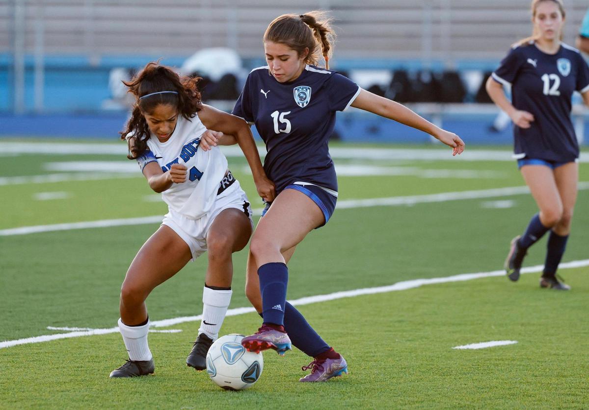 South Dade Senior High School’s Nicole Pedraja (4) and Palmetto High Schools Maya Lara (15) fight for possession of the ball at Traz Powell Stadium in Miami on Friday, January 13, 2023.