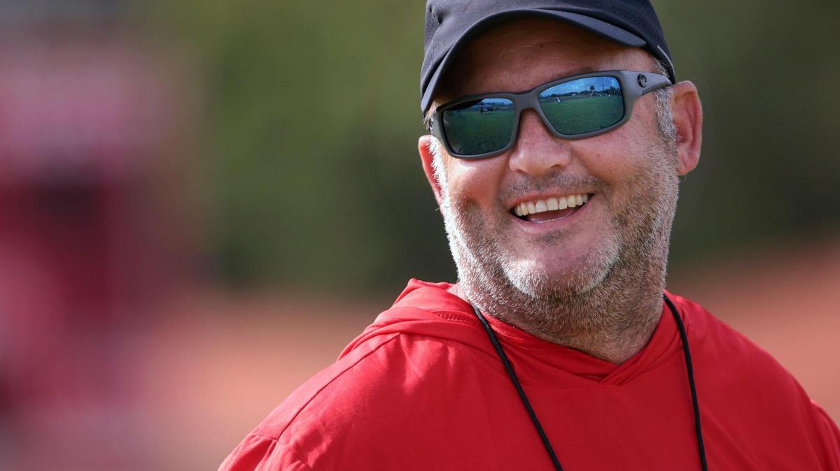 On Tuesday August 9, 2022 oral Gables High School football coach Frank Welsh, who recently has been coaching while battling colon cancer, smiles as he greets players and coaches while conducting morning practice at Coral Gables High’s football field.