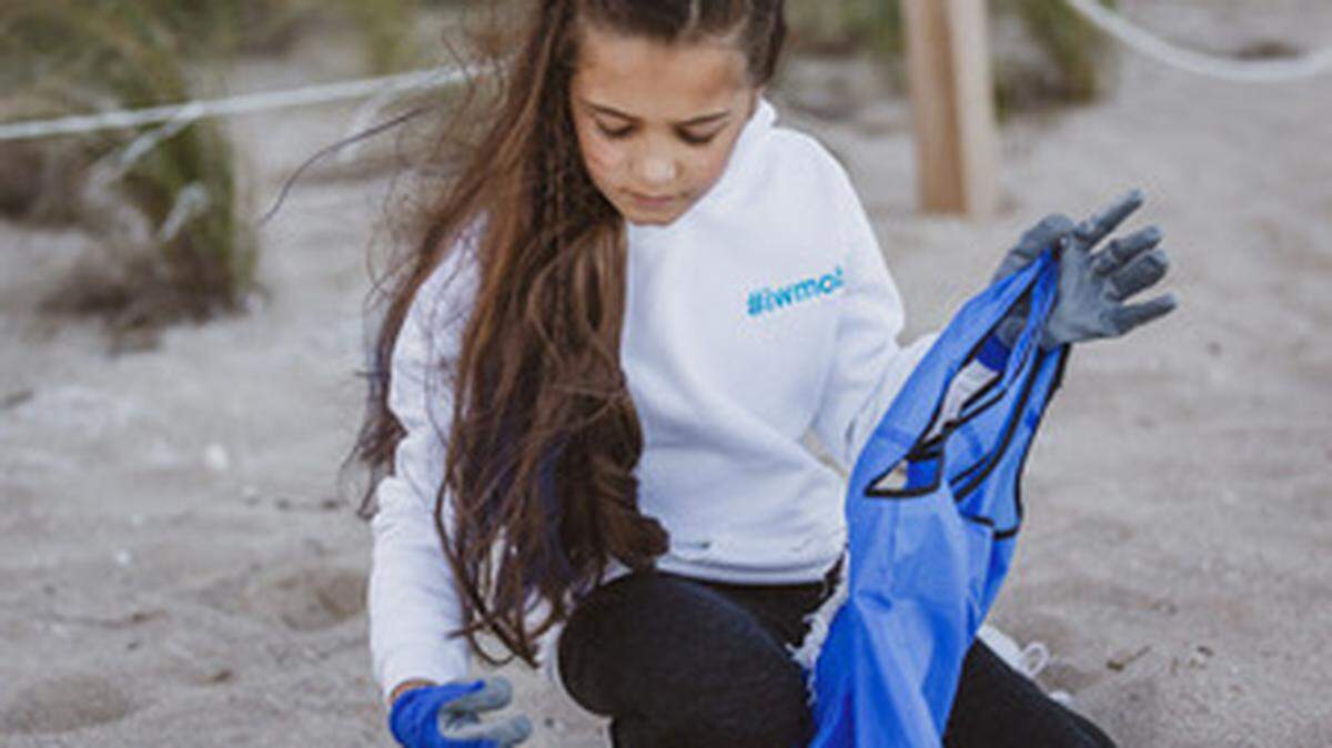 Sasha Olsen, 10, picking up a piece of micro-plastic she found during a January beach cleanup at Bal Harbour that she organized through the nonprofit she created with her cousin, Iwantmyoceanback.
