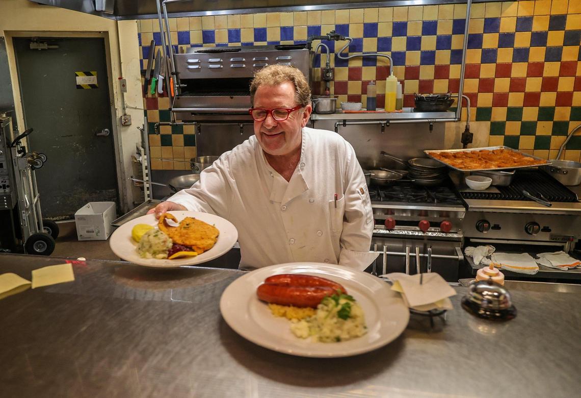 Fritz & Franz Bierhaus owner Harald Neuweg brings out some dishes out of the kitchen of his iconic restaurant in December 2023 before he signed the new lease with the city of Coral Gables.