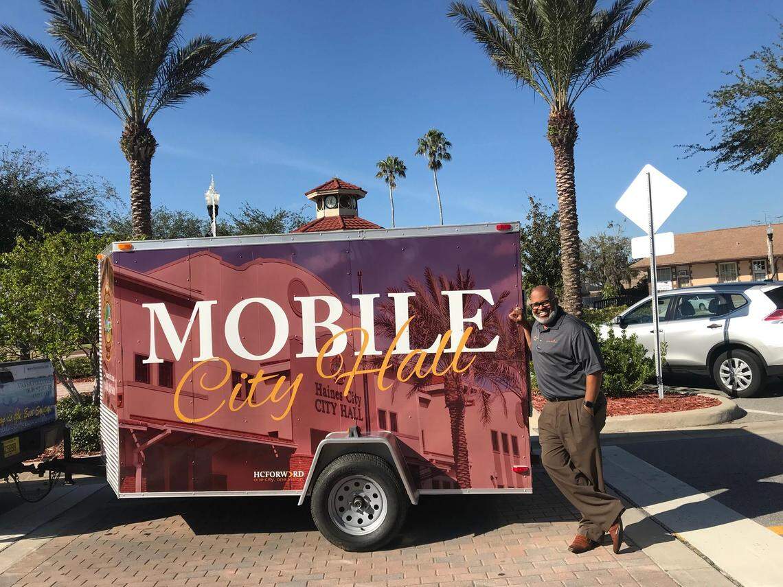 Deric Feacher, the Haines City manager, stands in front of a trailer he converted into a mobile city hall.