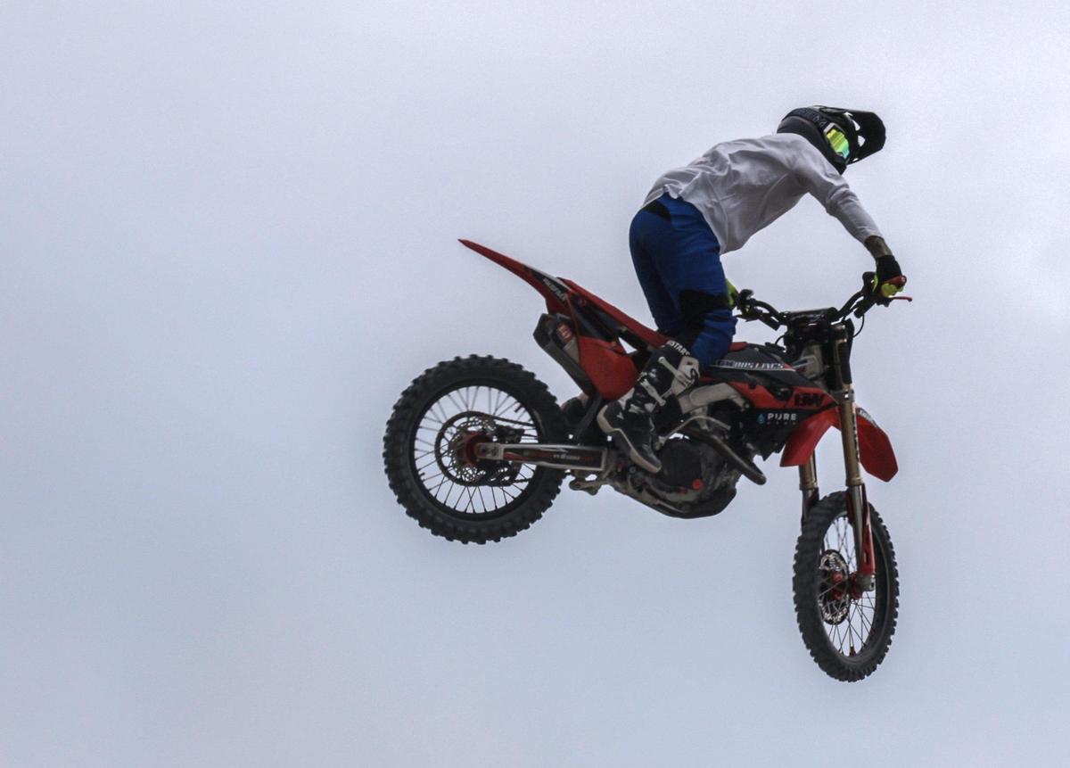 Brody Wilson, 36, takes to the air. On Sunday, May 29, 2022 motorcycle acrobatics met military precision in South Beach Sunday, as an Air Force honor guard performed drills on the sand as professional motorcross drivers jump their bikes 70 feet above in Lummus Park in South Beach.