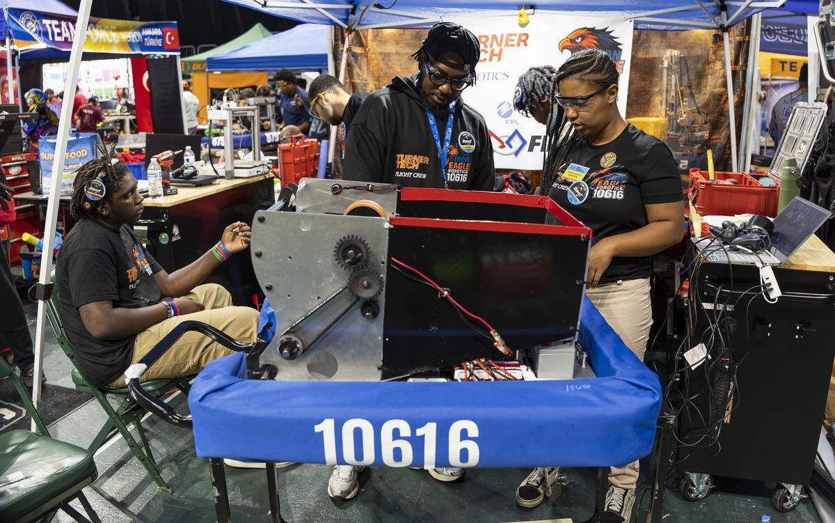 William H. Turner Technical Arts High School student Shayna Smith, 17, right, a member of Iron Eagle Robotics, and her coach, Jervin Thompson, center, overlook their team’s robot, Iron Ruckus, as they prepare to compete in the 2026 FIRST Robotics South Florida Regional Competition at the University of Miami’s Watsco Center on Friday, April 10, 2026, in Coral Gables, Fla. Participants from local school districts, surrounding states, and international teams are competing for an opportunity to earn a spot at the 2026 FIRST World Championship.