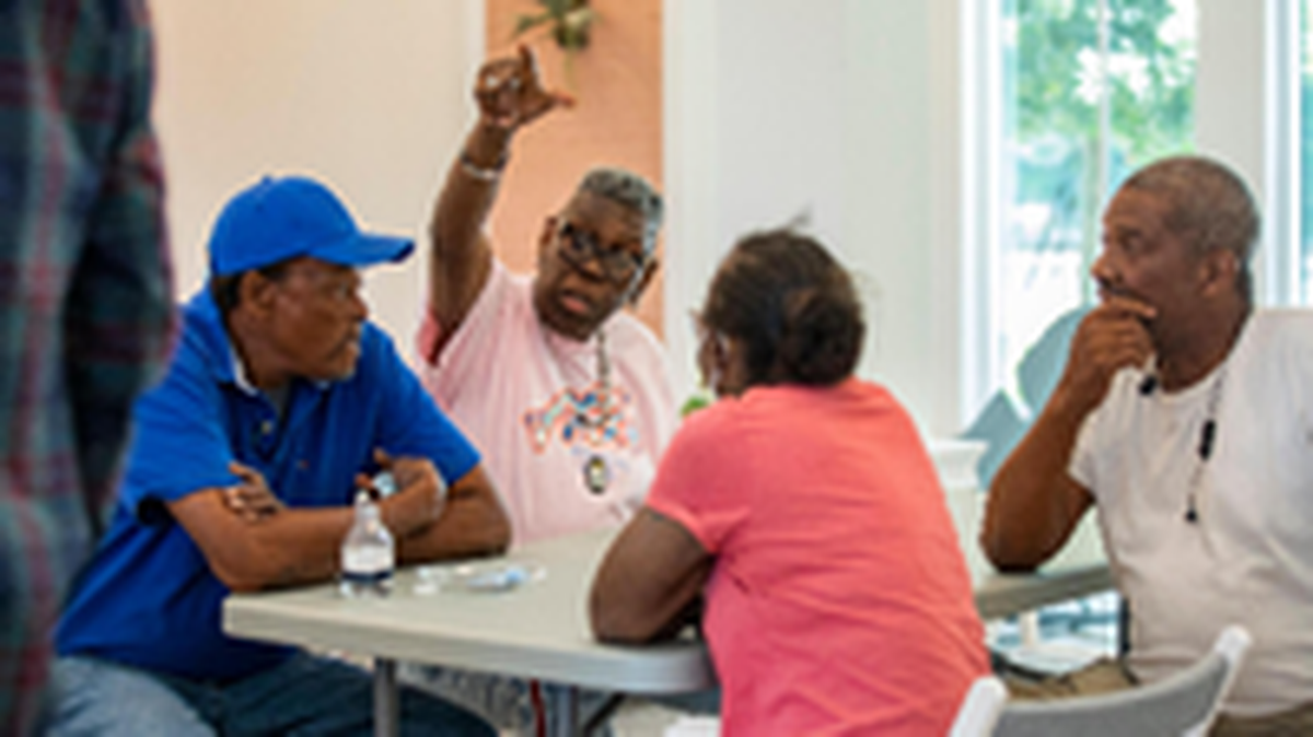 Residents of Father Marquess-Barry Apartments enjoy the community room in the new Overtown apartment complex for seniors.