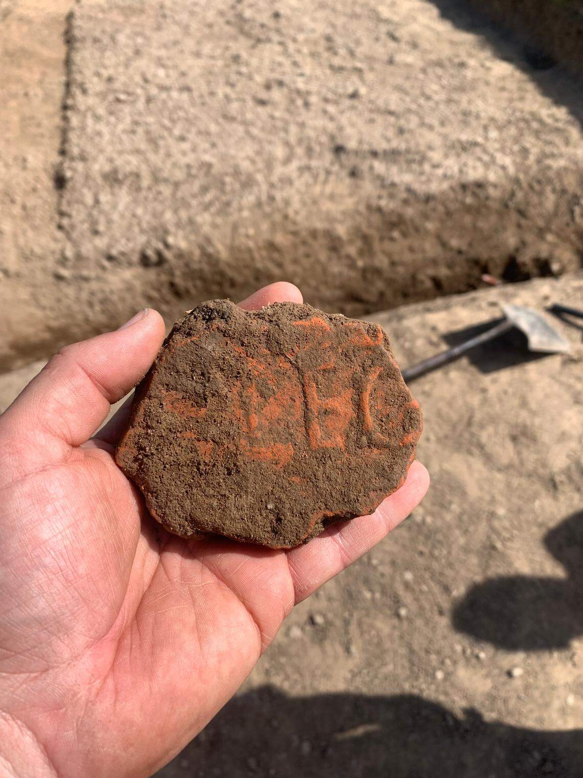 A stamped tile matched the style of Roman tiles found in a nearby field.