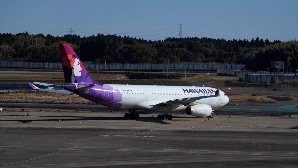This photo shows a Hawaiian Airlines plane at the Narita International Airport in Narita, east of Tokyo, Thursday, Dec. 2, 2021.
