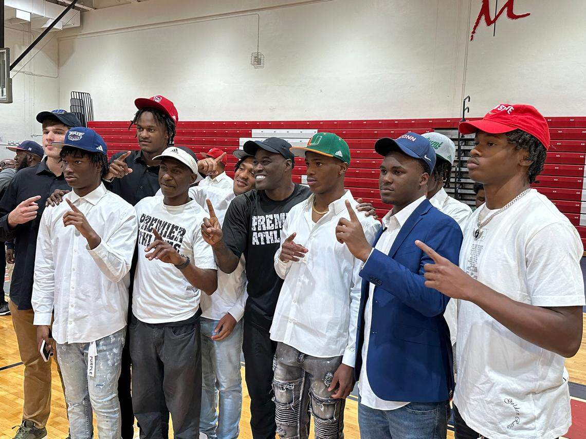 Chaminade football players including Jeremiah Smith (right) pose after signing with their respective schools on Wednesday at a ceremony at the Lions’ gym.