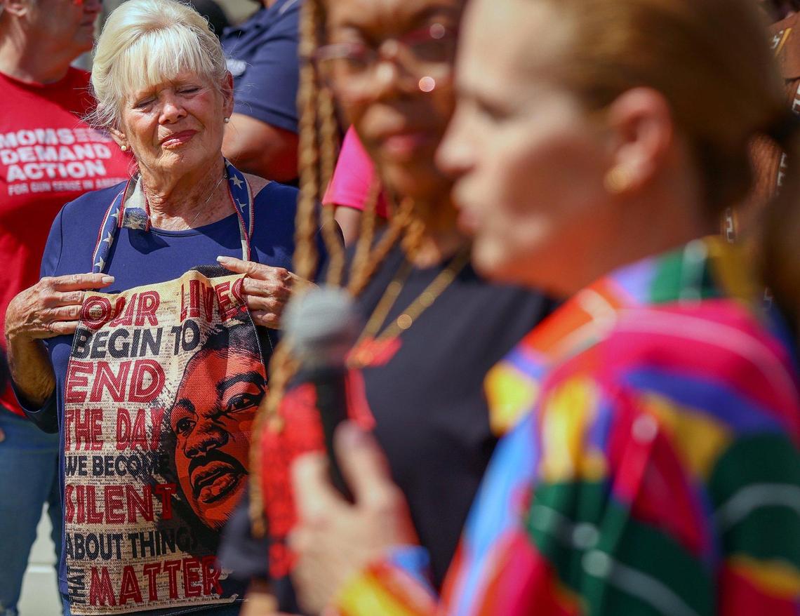 Circle of Brotherhood’s supporter Stephanie Rupp, left, and other community leaders came in support of the organization at a rally to address their budget shortfall due to cuts in federal funds.