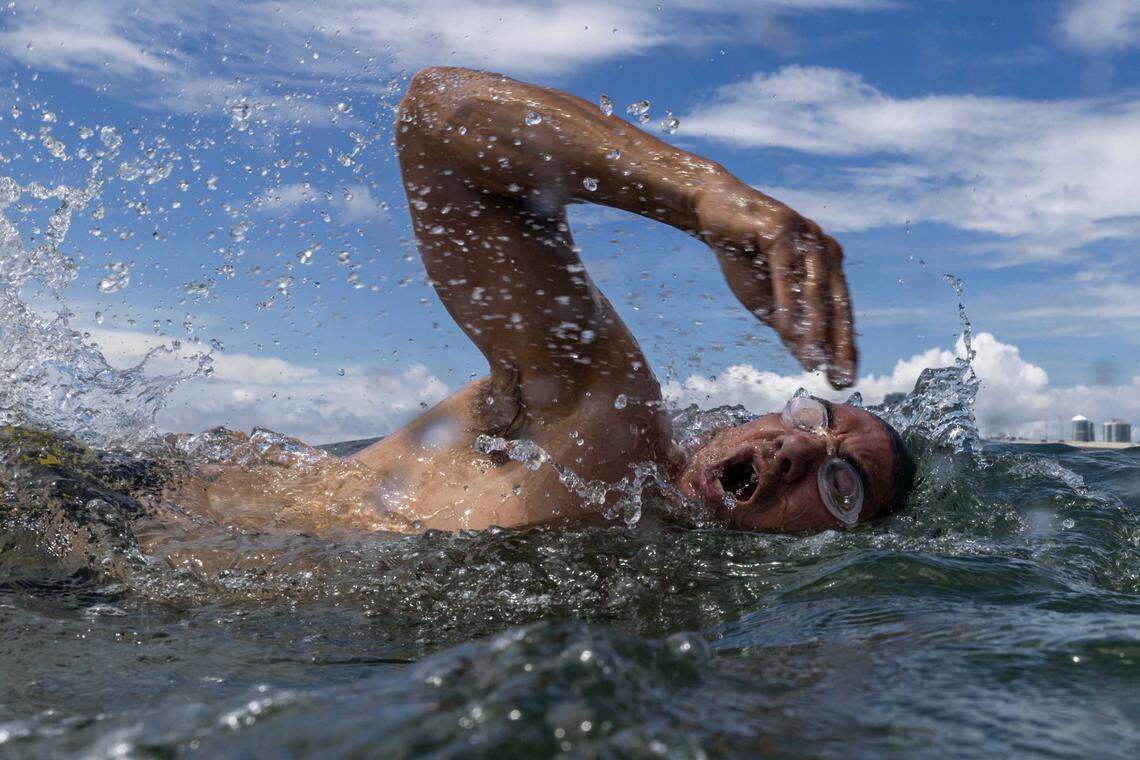 A swimmer moves along the beach at Hobie Island Beach on Monday, September 1, 2025, in Key Biscayne, Fla.