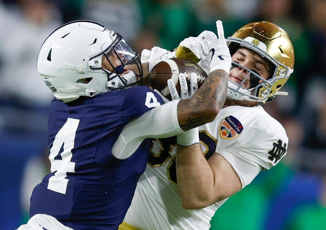 Penn State Nittany Lions cornerback A.J. Harris (4) defends against Notre Dame Fighting Irish tight end Mitchell Evans (88) as Evans completes the pass for a first down in the first half of their NCAA Playoff Semifinal Capital One Orange Bowl football game at Hard Rock Stadium in Miami Gardens, Florida on Thursday, January 9, 2025.