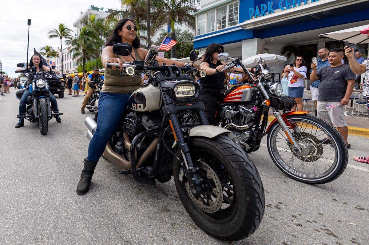 Parade participants straddle motorcycles as they drive down Ocean Drive during the 16th Annual Veterans Day Parade on Monday, Nov. 11, 2024, in Miami Beach, Fla.