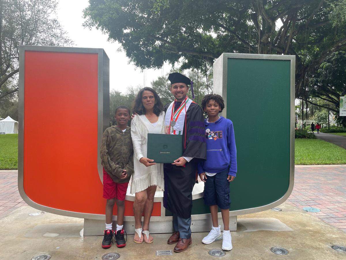 Angel Sanchez with his mother and nephews after graduating with his law degree from the University of Miami.