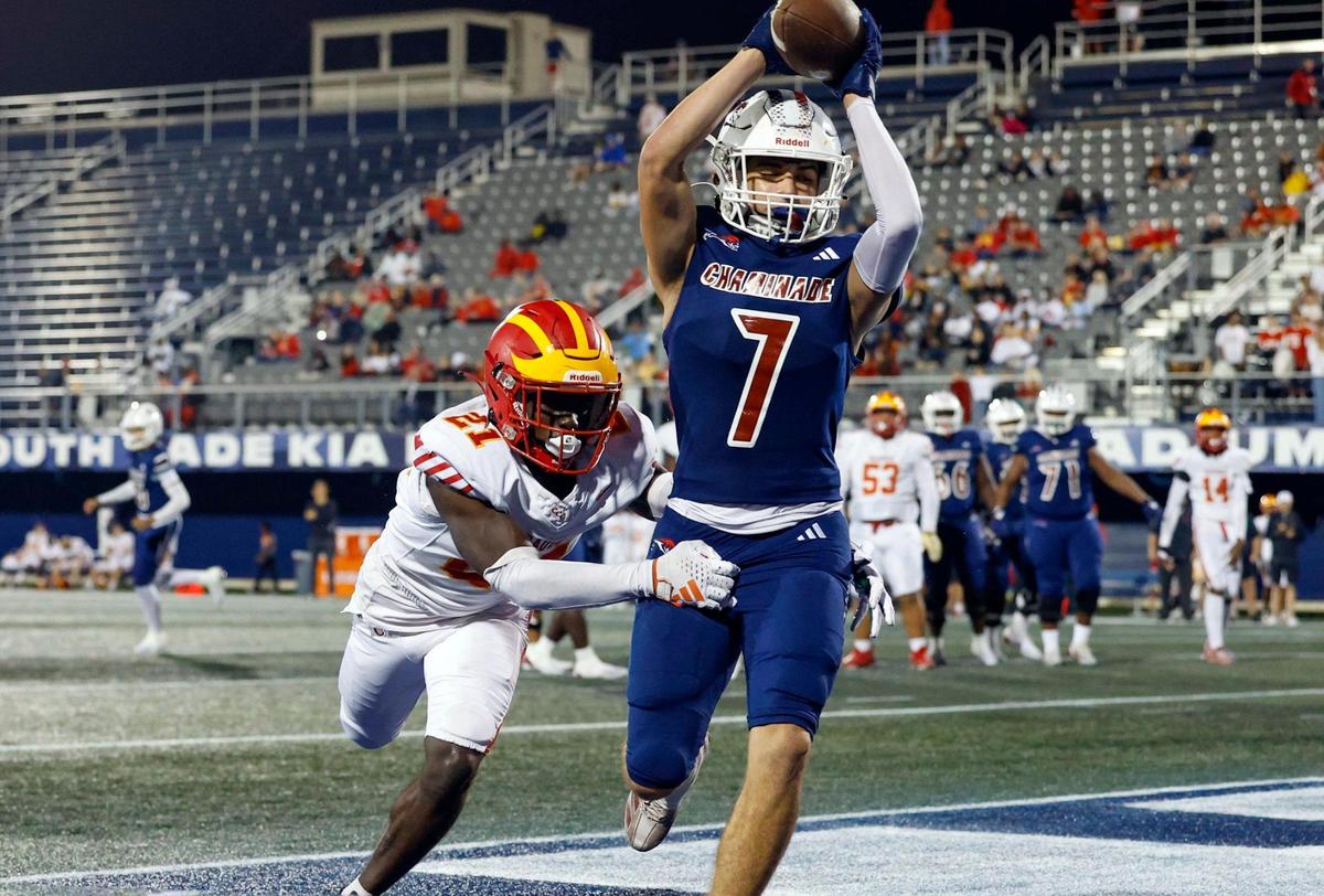 Chaminade-Madonna’s Jasen Lopez (7) on a touchdown reception as Clearwater Central Catholic’s Forrest Loving (21) defends in the second half of the Florida High School Football State Championships - Class 1A game at Pitbull Stadium on the campus of Florida International University in Miami, Florida, on Wednesday, December 11, 2024.