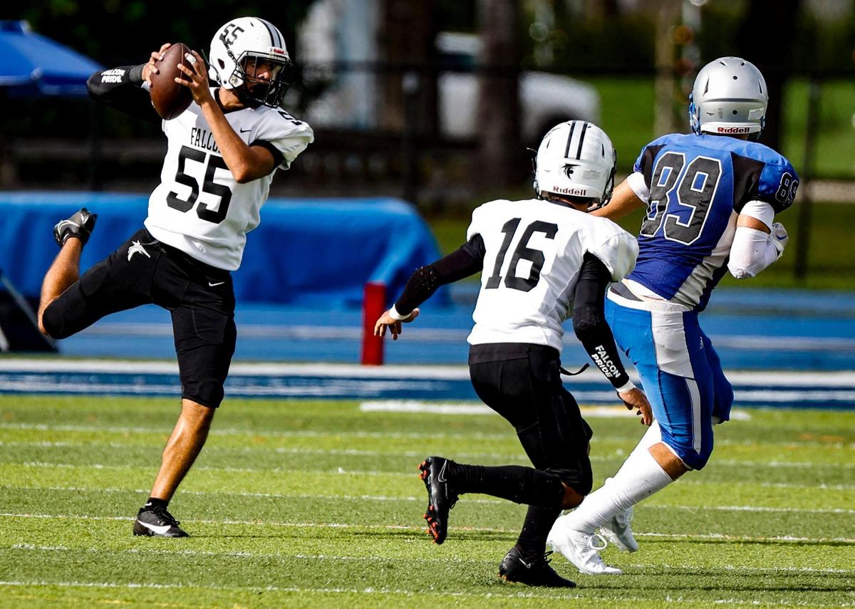 John A. Ferguson Senior High School’s defensive end Andres Lopez (55) intercepts the ball in the first half during the game against G. Holmes Braddock Senior High at the GMAC independent schools championship at Tropical Park on Thursday, November 16, 2023.