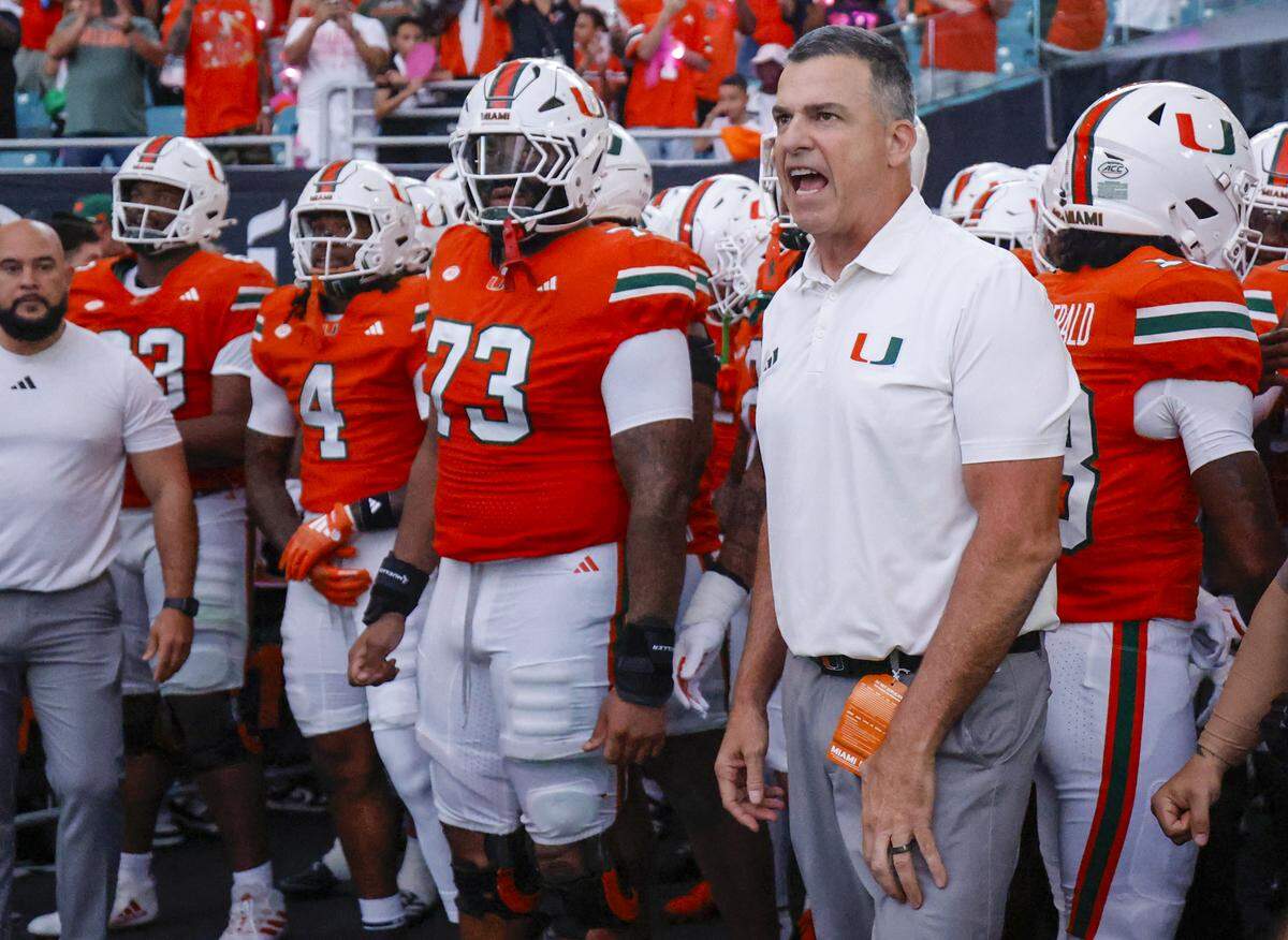 Miami Hurricanes head coach Mario Cristobal prepares to rush the field for their NCAA football game against the Louisville Cardinals at Hard Rock Stadium in Miami Gardens, Florida, on Friday, October 17, 2025.