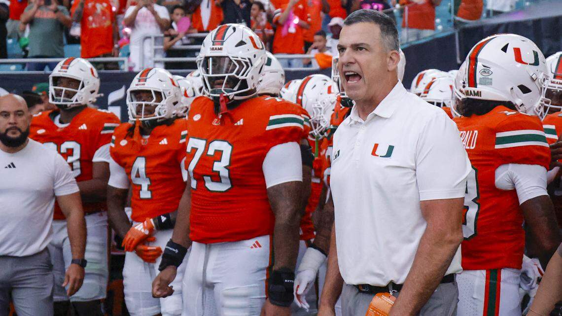 Miami Hurricanes head coach Mario Cristobal prepares to rush the field for their NCAA football game against the Louisville Cardinals at Hard Rock Stadium in Miami Gardens, Florida, on Friday, October 17, 2025.