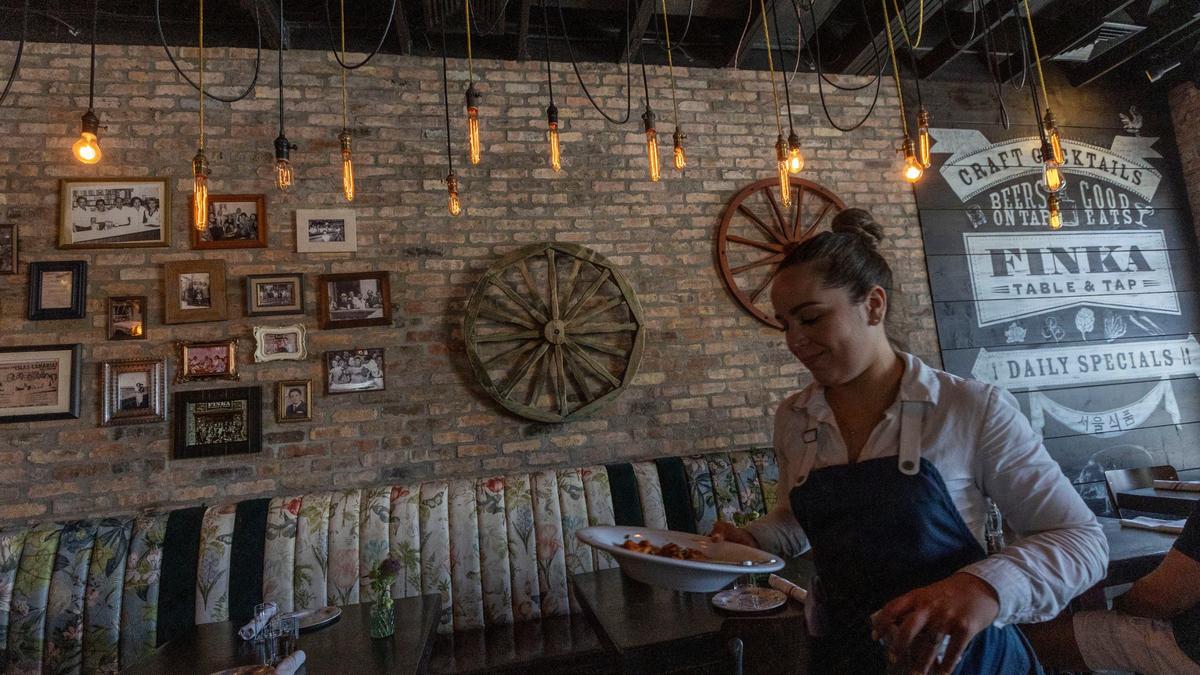 Waitress Heidi Perez works the lunch crowd at Finka Table & Tap in Kendall.