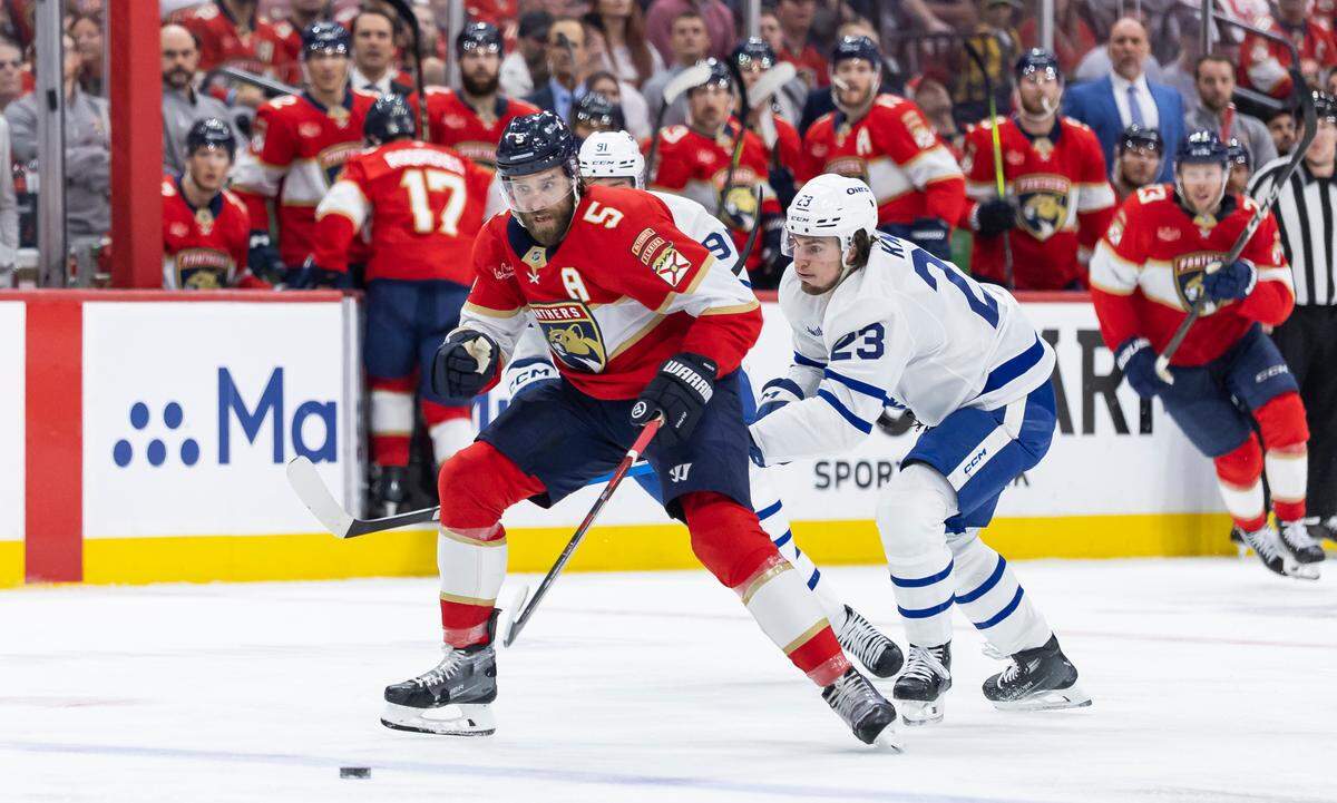 Florida Panthers defenseman Aaron Ekblad (5) and Toronto Maple Leafs left wing Matthew Knies (23) compete for the puck in the first period of Game 3 of a second-round Stanley Cup playoffs series at the Amerant Bank Arena on Friday, May 9, 2025, in Sunrise, Fla.