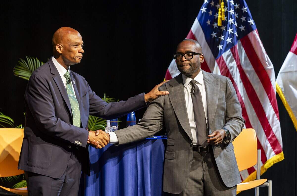 Former Miami-Dade commissioner Oliver Gilbert, left, and Florida State Senator Shevrin Jones shake hands as they attend a town hall debate ahead of the U.S. House Florida District 24 race at Florida Memorial University on Tuesday, June 30, 2026, in Miami Gardens, Fla.