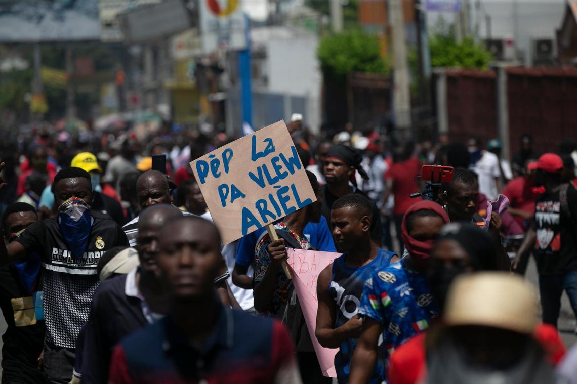 A man carries a sign with a message that reads in Creole; “The people don’t want you Ariel,” during a protest to demand that Haitian Prime Minister Ariel Henry step down and a call for a better quality of life, in Port-au-Prince, Haiti, Wednesday, Sept. 7, 2022.