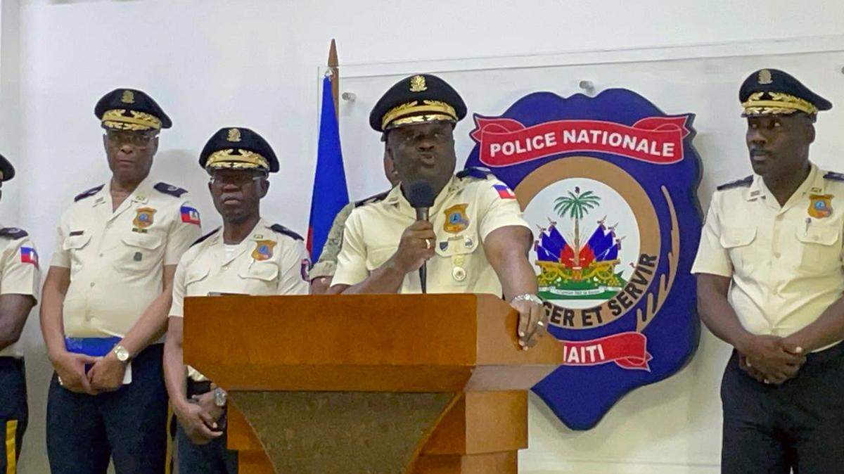 Haiti Police Chief Frantz Elbé, center, addresses journalists on Monday, Aug. 28, 2023, two days after church members were shot and killed by a powerful gang as they marched against the armed group.