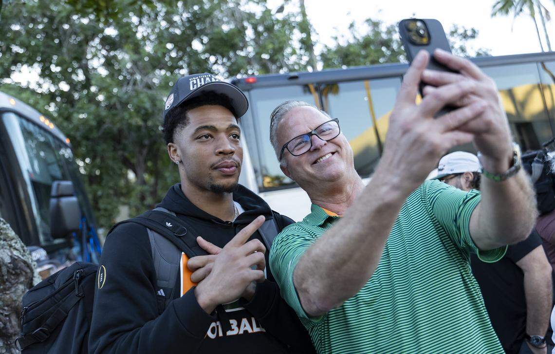 Miami Hurricanes wide receiver CJ Daniels (7) takes a selfie with Michael Leblanc near the Hecht Athletic Center on Friday, Jan. 9, 2025, in Coral Gables, Fla. The University of Miami returned home after winning the Fiesta Bowl on Thursday against Ole Miss at State Farm Stadium in Glendale, Ariz.