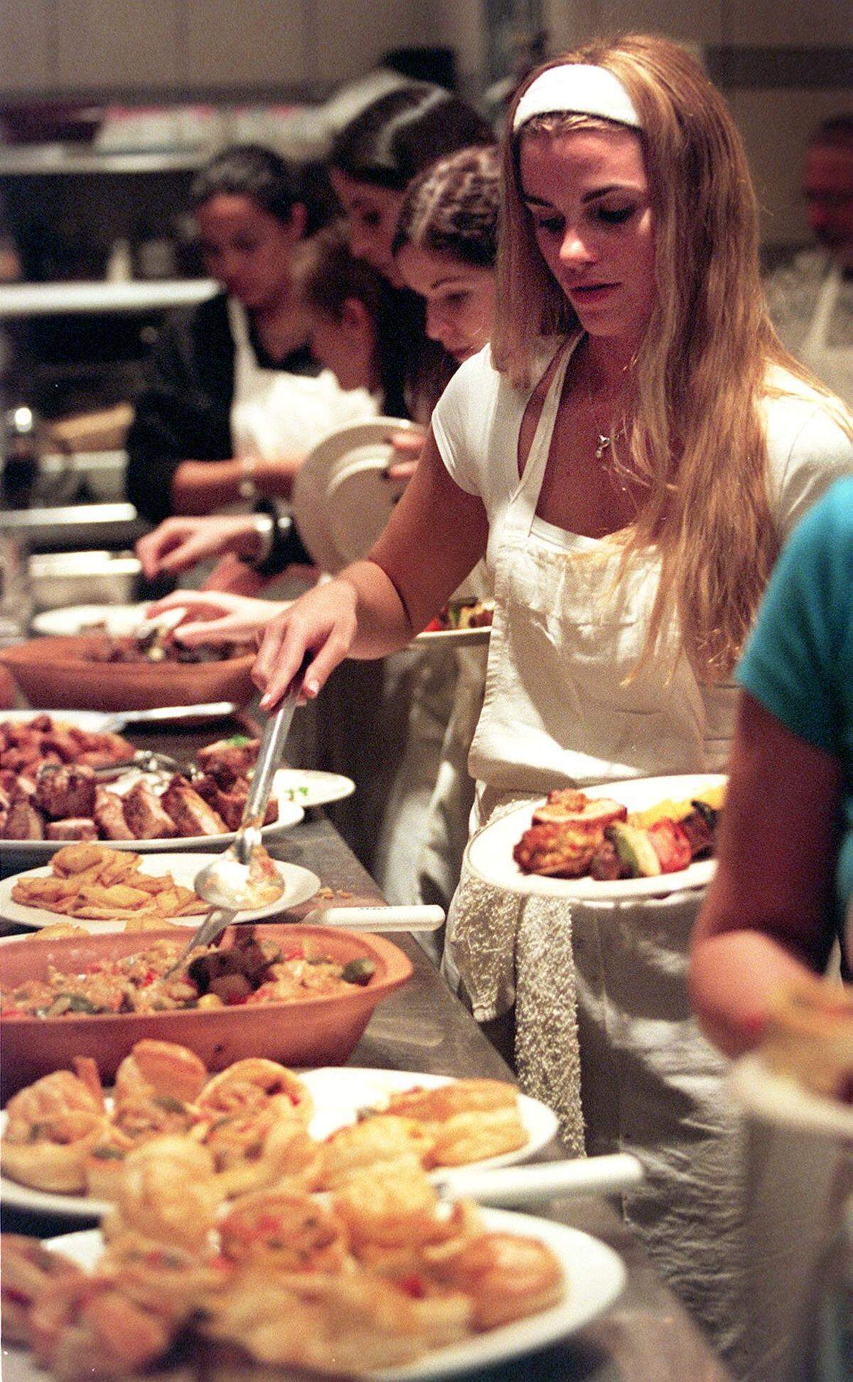 In 2001, Herald writer Annie Vazquez makes her way through the buffet line after her cooking class finished preparation of the food. She went to cooking class at Two Chefs restaurant in South Miami.