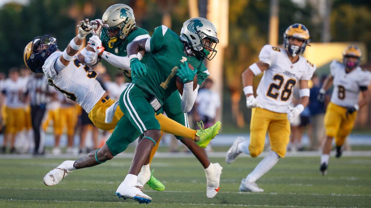 Immaculata-La Salle High School’s wide receiver Brandon Kinsey (1) carries the ball against Belen Jesuit in the first half at Tropical Park Stadium in Miami, Florida, on Friday, September 6, 2024.