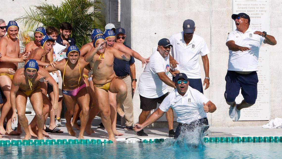 Belen Jesuit’s water polo players and coaches celebrate victory against Orlando’s Dr. Phillips during the State Water Polo Boys final game on Saturday, April 23, 2022 in Miami. Andrew Uloza / for THE MIAMI HERALD