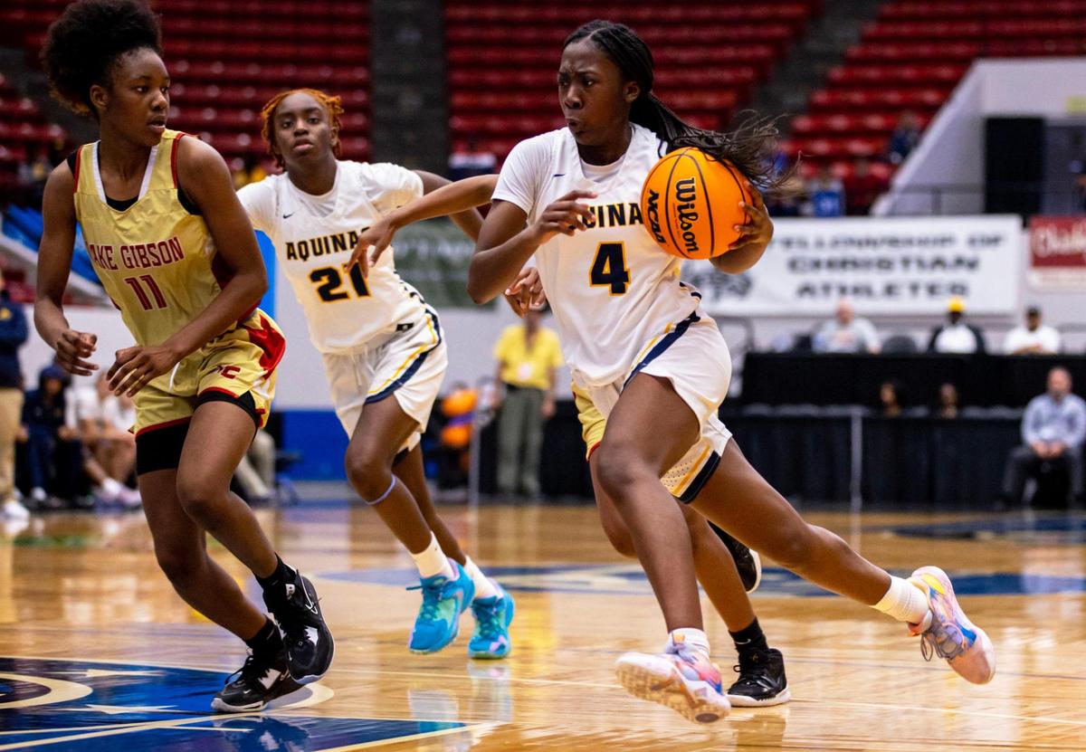 St. Thomas Aquinas guard Karina Gordon (4) drives down the court while defended by Lake Gibson’s Jamila Ray (11) during the Class 6A Florida High School State Girl’s basketball Semifinal at RP Funding Center in Lakeland, Florida, on Thursday, February 23, 2023.