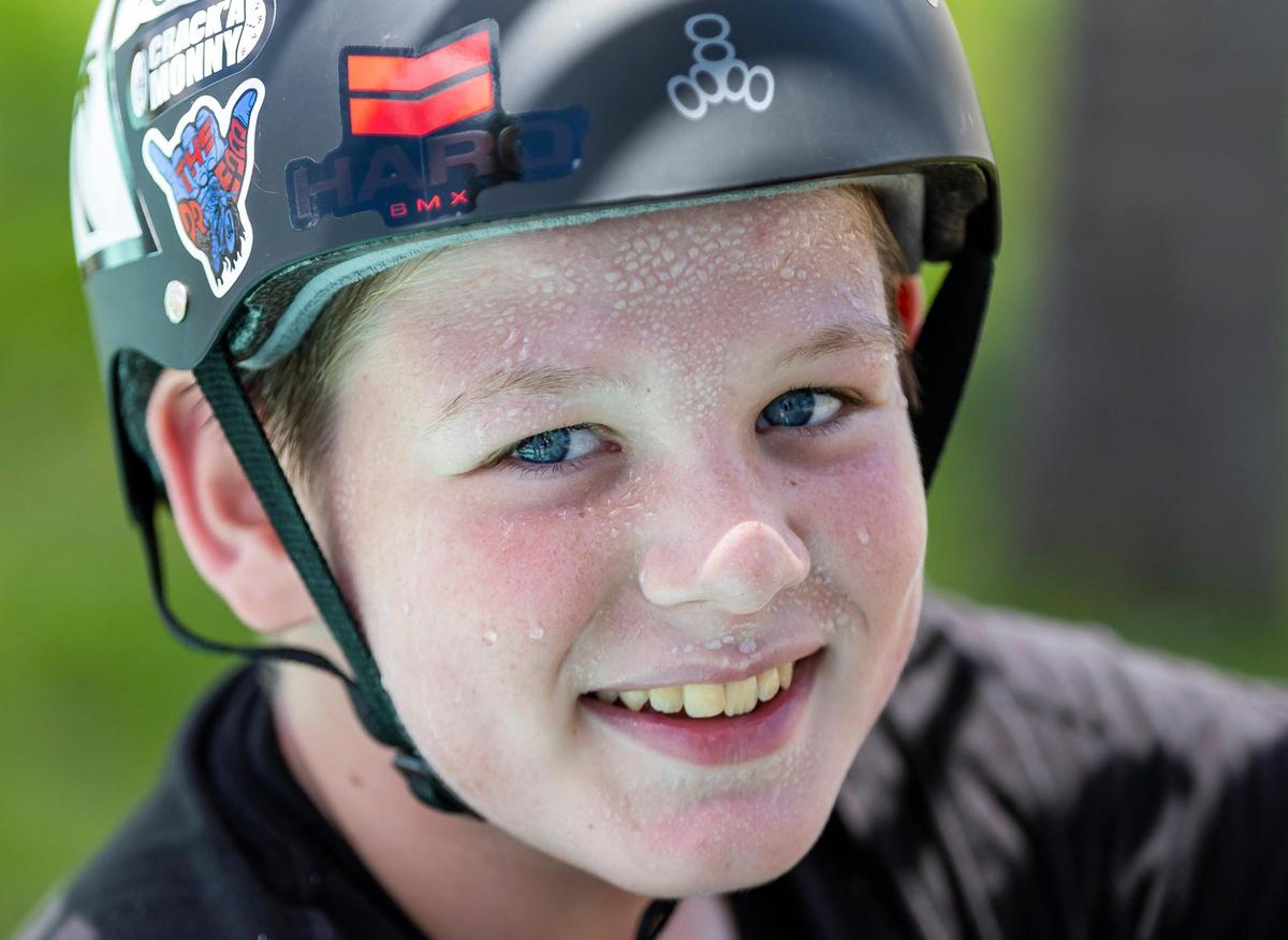 Beads of sweat gather on Henry McElwain,13, while he takes a break from riding his scooter at Haulover Skateboard Park on Wednesday, June 14, 2023, in Miami Beach, Fla. Miami-Dade County issued a heat advisory for residents after the National Weather Service estimated the heat index would reach between 105 and 108 degrees.