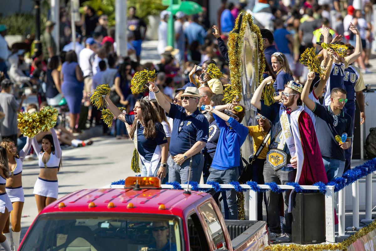 The Florida International University float rides by the mainstage while University President Mark B. Rosenberg waves to parade goers during the 45th Annual Winternational Thanksgiving Day Parade in front of North Miami City Hall in North Miami, Florida on Thursday, November 28, 2019.