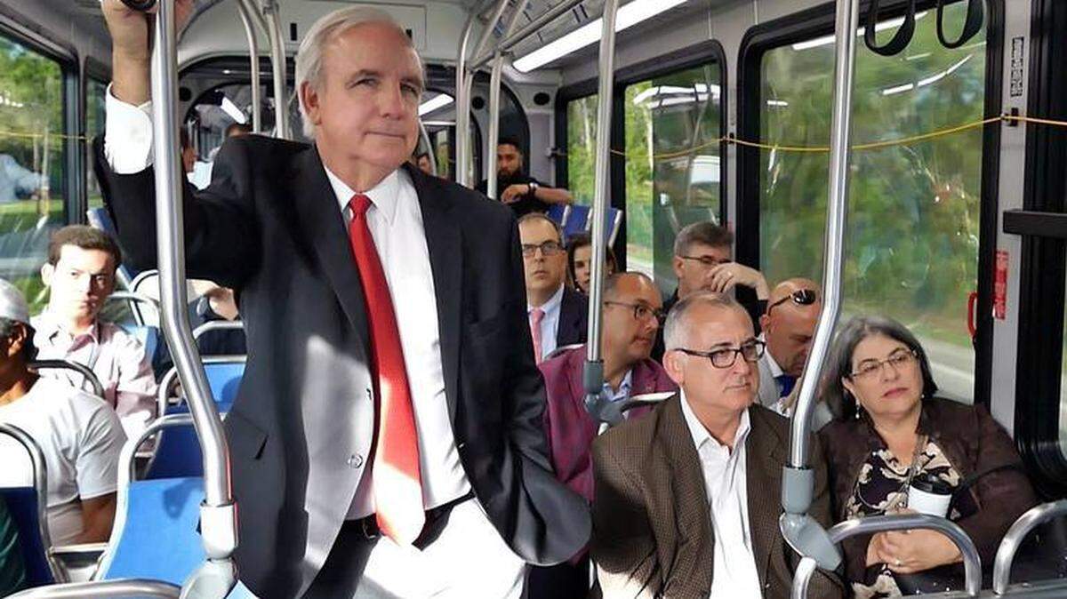 Mayor Carlos Gimenez during a 2018 demonstration of express buses on the South Dade busway. In early 2019, he and his wife, Lourdes Gimenez, agreed to be in a promotional video for a proposed monorail between Miami and Miami Beach.