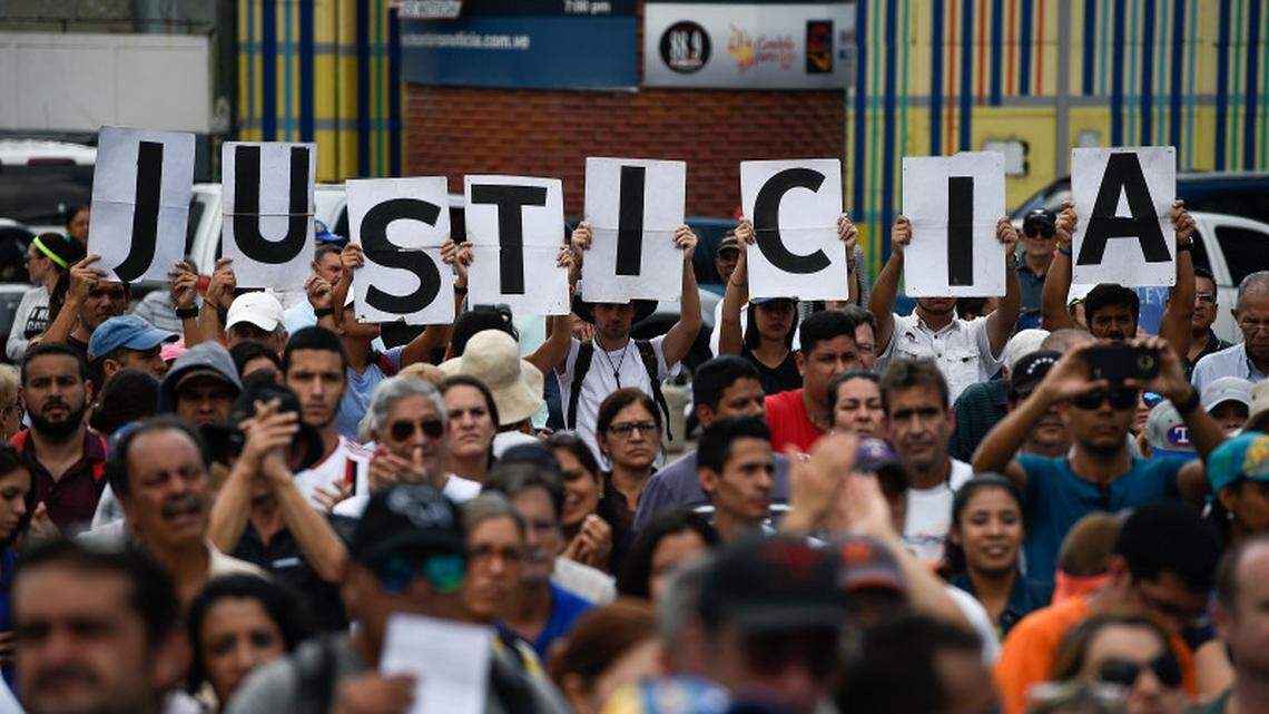 Supporters of Venezuela’s opposition hold up letters reading “Justice” during a rally in Caracas in January.
