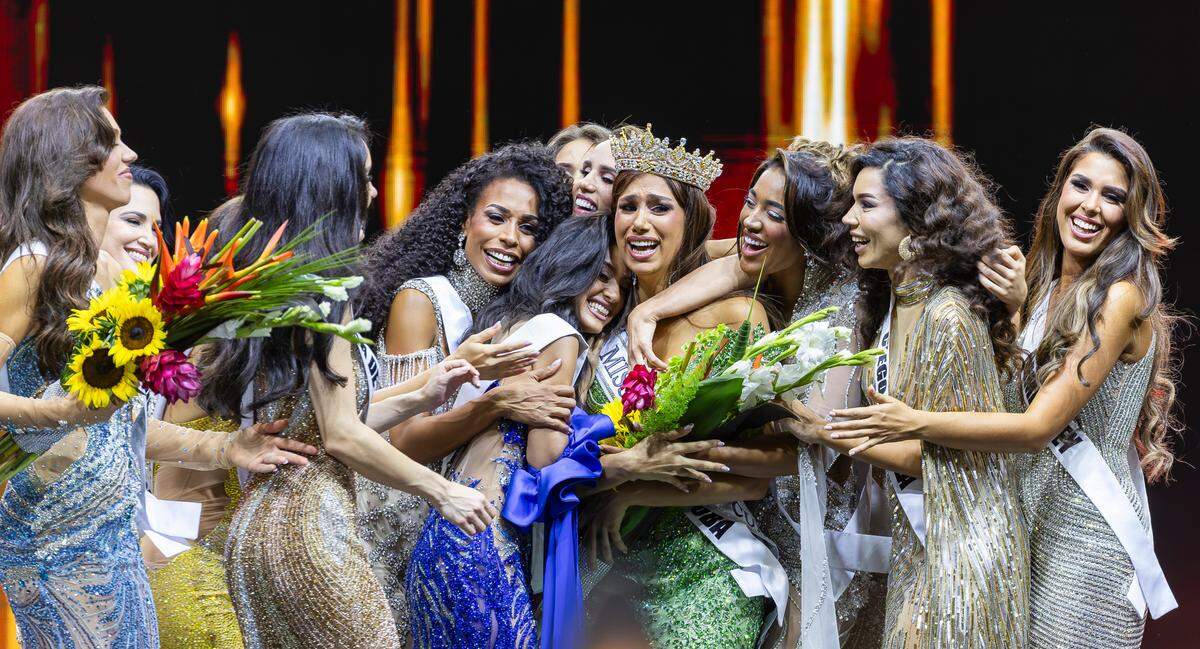 Lina Luaces, center, is hugged by all the contestants after she being crowned Miss Universe Cuba 2025 during the beauty pageant at Milander Park on Tuesday, July 8, 2025, in Hialeah, Fla.