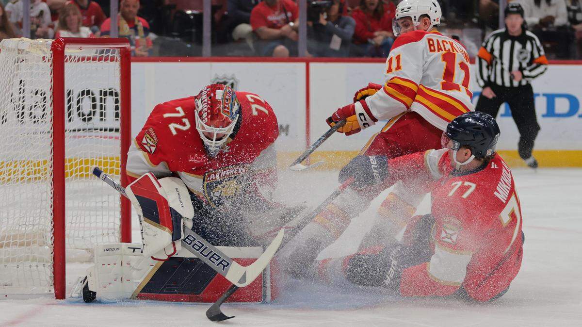 Mar 1, 2025; Sunrise, Florida, USA; Florida Panthers goaltender Sergei Bobrovsky (72) makes a save against Calgary Flames center Mikael Backlund (11) during the first period at Amerant Bank Arena.