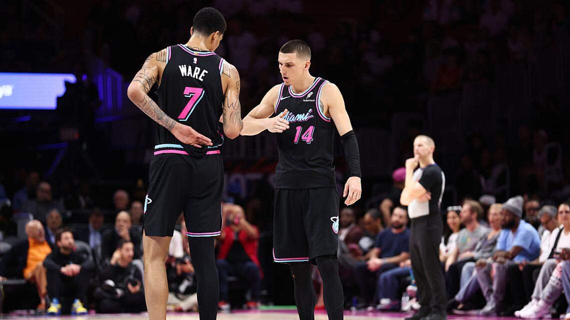 Kel'el Ware #7 and Tyler Herro #14 of the Miami Heat celebrate during the fourth quarter of the game against the Houston Rockets at Kaseya Center on February 28, 2026 in Miami, Florida.