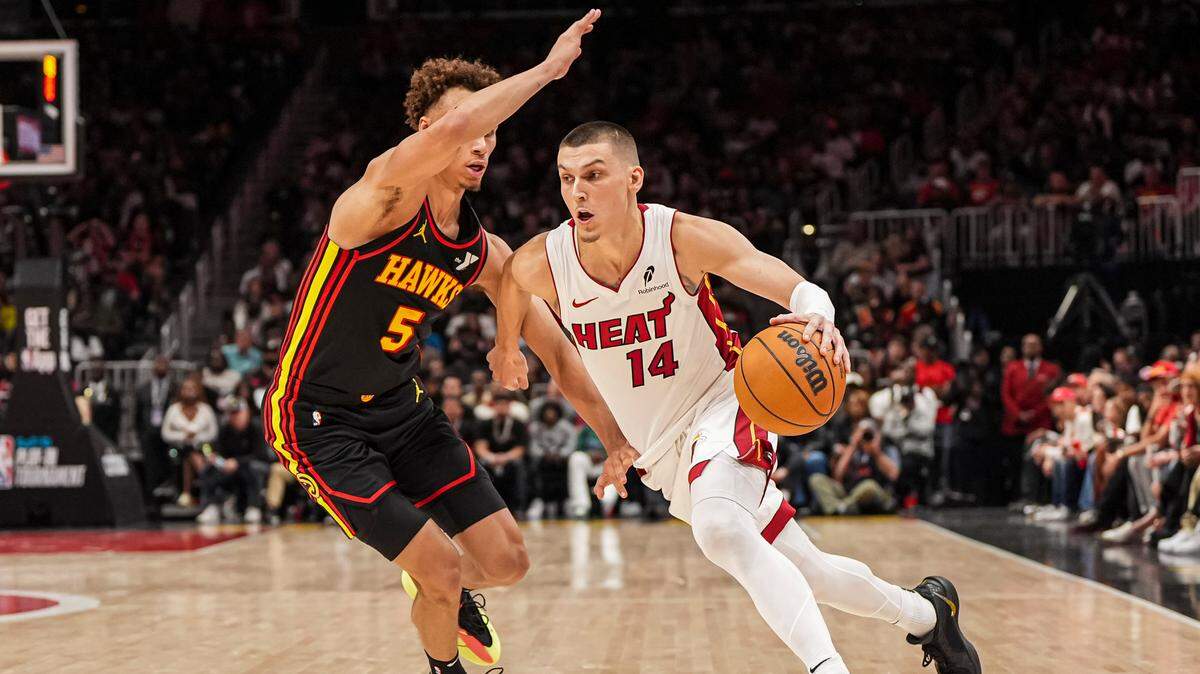Miami Heat guard Tyler Herro (14) dribbles past Atlanta Hawks guard Dyson Daniels (5) during the second half at State Farm Arena.