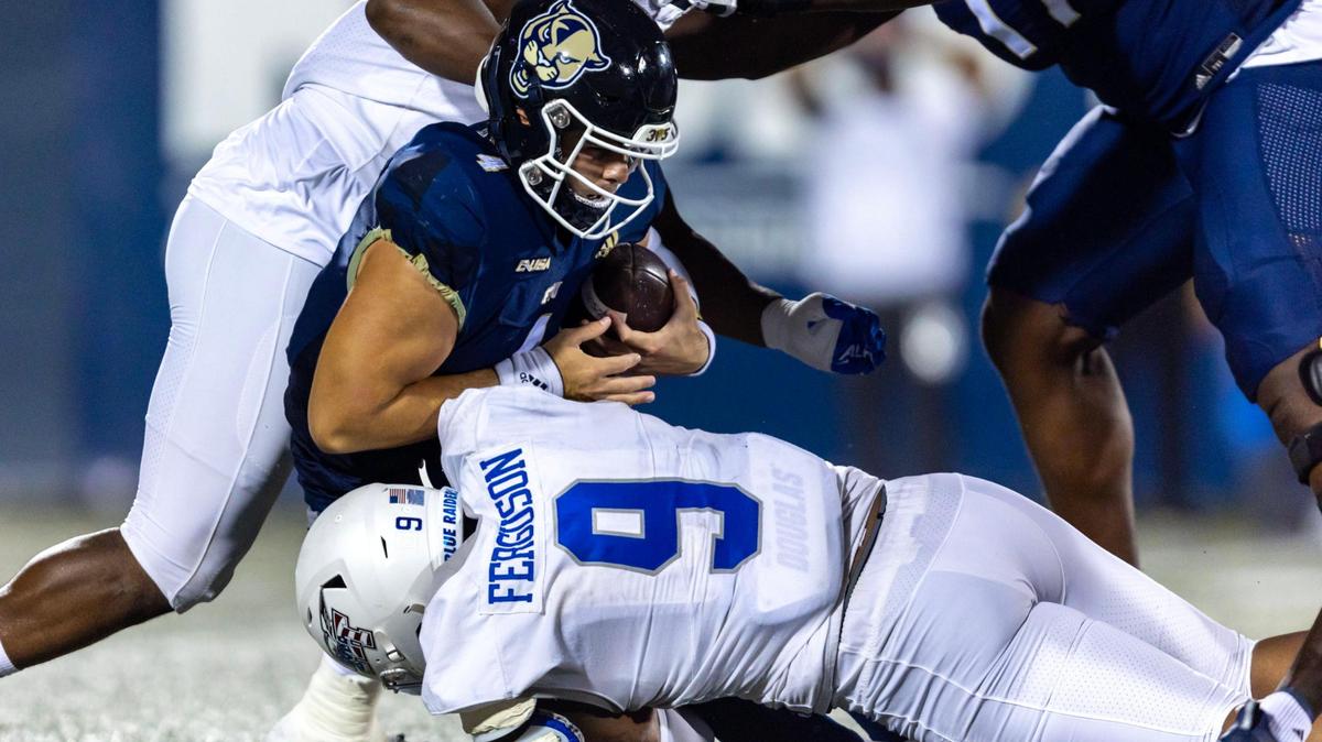 Florida International University quarterback Haden Carlson (4) is sacked by Middle Tennessee defensive end Jordan Ferguson (9) during the first half of an NCAA Conference USA football game at Riccardo Silva Stadium in Miami, Florida, on Saturday, November 26, 2022.